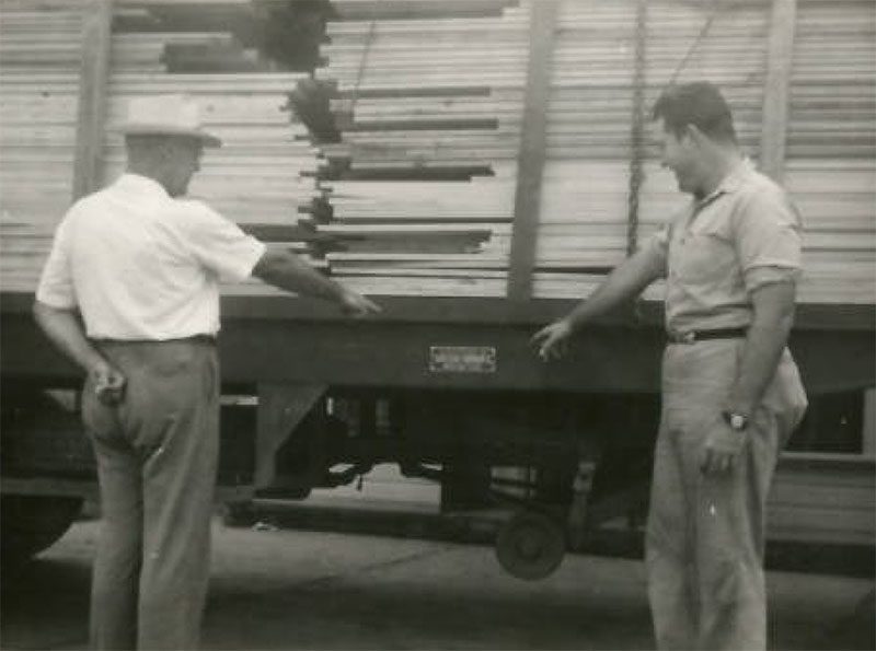 LW Buddy Ledwell and his father inspecting lumber truck